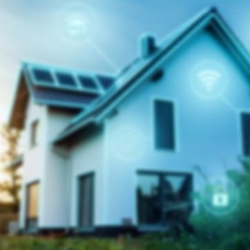 A modern house with rooftop solar panels and smart-home icons